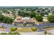 This aerial view captures the community with a clubhouse, pool, parking, landscaping, and several tennis courts at 10031 Sw 62Nd Cir, Ocala, FL 34476