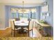 Dining area with chandelier, round table with seating, and window with natural light at 10031 Sw 62Nd Cir, Ocala, FL 34476
