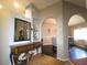 Inviting foyer with decorative console table, arched doorways leading to dining room, and neutral paint at 10031 Sw 62Nd Cir, Ocala, FL 34476