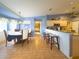 Open-concept kitchen and breakfast nook area with tiled flooring, breakfast bar, and view to next room at 10031 Sw 62Nd Cir, Ocala, FL 34476