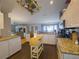 Well-lit kitchen with granite countertops, stainless steel appliances, and a mobile wooden island at 10031 Sw 62Nd Cir, Ocala, FL 34476