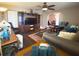 Comfortable living room with dark wood floors, a large entertainment center, and arched doorway at 10031 Sw 62Nd Cir, Ocala, FL 34476