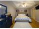 Cozy main bedroom with hardwood floors, a comfortable bed, and decorative accents at 10031 Sw 62Nd Cir, Ocala, FL 34476