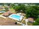 Aerial view of a large in-ground pool, hot tub, recreation structure, and seating within a well-maintained community area at 10031 Sw 62Nd Cir, Ocala, FL 34476