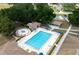 Aerial view of a large in-ground community pool, hot tub, covered seating and tables in a well-maintained community area at 10031 Sw 62Nd Cir, Ocala, FL 34476