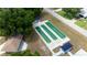 An aerial view displays lawn bowling with three carpeted lanes between shelters, creating a recreational community space at 10031 Sw 62Nd Cir, Ocala, FL 34476