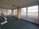 Bright sunroom with lots of windows and green carpet at 10031 Sw 62Nd Cir, Ocala, FL 34476