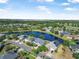 Beautiful aerial view of a lakeside community featuring well-manicured lawns and mature trees at 117 Hagge Dr, Daytona Beach, FL 32124