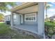 Back porch with gray floors and pillars overlooking backyard at 117 Hagge Dr, Daytona Beach, FL 32124