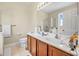 This bathroom features a large double sink vanity, tile floors, and a door at 117 Hagge Dr, Daytona Beach, FL 32124