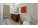 Bathroom features a double sink vanity, a toilet, neutral walls, and a decorative towel hanging on the wall at 117 Hagge Dr, Daytona Beach, FL 32124