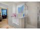 This bathroom features a soaking tub, a glass enclosed shower, and a view into an adjacent bedroom at 117 Hagge Dr, Daytona Beach, FL 32124
