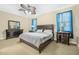 This bedroom features carpet, a ceiling fan, and a complete dark wood bedroom suite at 117 Hagge Dr, Daytona Beach, FL 32124
