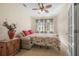 Cozy bedroom with a ceiling fan, a pull-out bed, two windows, and neutral-toned decor at 117 Hagge Dr, Daytona Beach, FL 32124