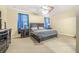 This bedroom features carpet, a ceiling fan, and a dark wood bedroom suite at 117 Hagge Dr, Daytona Beach, FL 32124