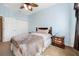 This bedroom offers a white closet door, light blue walls, carpeted floors, and a ceiling fan at 117 Hagge Dr, Daytona Beach, FL 32124