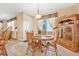 Warm, inviting dining area with a wooden table set and natural light streaming through the window at 117 Hagge Dr, Daytona Beach, FL 32124