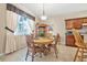 Charming dining area with a round wooden table set, window, and lovely natural lighting at 117 Hagge Dr, Daytona Beach, FL 32124