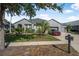 Beautiful gray single-story home with an attached three-car garage, a green lawn, and neatly trimmed landscaping at 117 Hagge Dr, Daytona Beach, FL 32124