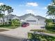 Attractive single-story home featuring a well-kept lawn, landscaping, a driveway, and an attached three-car garage at 117 Hagge Dr, Daytona Beach, FL 32124