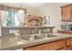 Practical kitchen featuring a double sink, ample countertop space, and a view into the dining area at 117 Hagge Dr, Daytona Beach, FL 32124