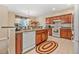 Well-equipped kitchen with wooden cabinets, appliances, and a breakfast bar at 117 Hagge Dr, Daytona Beach, FL 32124