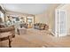 Open-concept living area with neutral walls, plush carpeting, and views into adjoining rooms at 117 Hagge Dr, Daytona Beach, FL 32124