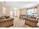 Comfortable living room features tan walls, neutral carpet, and comfortable seating arrangement at 117 Hagge Dr, Daytona Beach, FL 32124