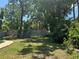 Spacious backyard featuring mature trees, privacy fence, and a fire pit area at 127 Mason Park Dr, Daytona Beach, FL 32117