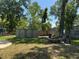 Backyard featuring mature trees, a storage shed, privacy fence and fire pit at 127 Mason Park Dr, Daytona Beach, FL 32117