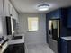 Modern kitchen featuring blue lower cabinets, white upper cabinets, and stainless steel appliances at 127 Mason Park Dr, Daytona Beach, FL 32117