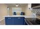 Kitchen featuring blue lower cabinets, quartz countertops and nautical themed hardware at 127 Mason Park Dr, Daytona Beach, FL 32117