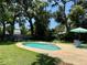 Backyard pool with surrounding deck and outdoor seating with lush landscaping at 127 Mason Park Dr, Daytona Beach, FL 32117