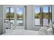 Bright bedroom boasts sliding glass doors, a picturesque lake view, and natural light at 129 Golden Eye Dr # C, Daytona Beach, FL 32119
