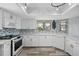 Well-lit kitchen boasting white appliances, granite counters, and decorative backsplash at 129 Golden Eye Dr # C, Daytona Beach, FL 32119
