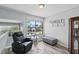 Cozy living room featuring a comfortable recliner, ottoman, and view of the neighborhood at 129 Golden Eye Dr # C, Daytona Beach, FL 32119