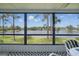 Screened-in patio boasts panoramic lake views and comfortable seating, creating a relaxing outdoor space at 129 Golden Eye Dr # C, Daytona Beach, FL 32119