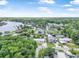 An aerial view of a charming neighborhood with waterfront homes, lush greenery, and a serene river at 24538 Wildhog Rd, Astor, FL 32102
