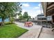 Waterfront backyard with a red picnic table, lush greenery, and a tranquil canal view at 24538 Wildhog Rd, Astor, FL 32102