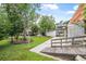 The lush backyard features mature trees, a ramp leading to the house, and a well-maintained lawn at 24538 Wildhog Rd, Astor, FL 32102