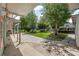 A large backyard area with lush trees and a concrete walkway leading to the waterfront at 24538 Wildhog Rd, Astor, FL 32102