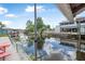 Waterfront backyard with lush greenery, a private dock, and a serene view of the canal at 24538 Wildhog Rd, Astor, FL 32102