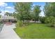 Beautiful backyard featuring lush green grass, mature trees, and waterfront access with a picnic table at 24538 Wildhog Rd, Astor, FL 32102
