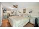 Cozy bedroom with a ceiling fan, a floral bedspread, and decorative wall sconces, offering a relaxing retreat at 24538 Wildhog Rd, Astor, FL 32102