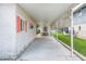 Spacious carport with white brick walls, red shutters, and a covered area for parking and outdoor activities at 24538 Wildhog Rd, Astor, FL 32102