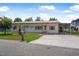 Charming white brick single-story home with a well-kept lawn and a convenient carport at 24538 Wildhog Rd, Astor, FL 32102