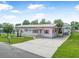 Lovely single-story home featuring a brick facade, tidy lawn, and convenient covered parking area at 24538 Wildhog Rd, Astor, FL 32102