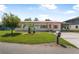 Charming single-story home with vibrant landscaping, brick facade, and covered parking at 24538 Wildhog Rd, Astor, FL 32102