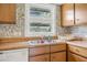 Cozy kitchen showcasing wood cabinets, stainless steel sink, and natural light at 24538 Wildhog Rd, Astor, FL 32102