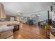 Open-concept living area with laminate floors, ample seating, and large windows at 24538 Wildhog Rd, Astor, FL 32102